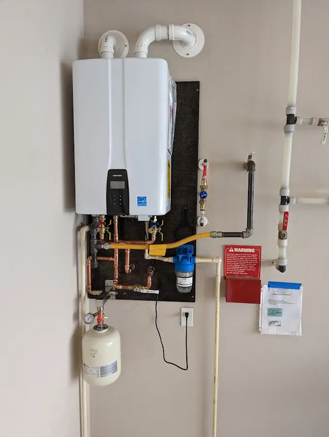 Professional plumber installing copper piping in a Dunbar home